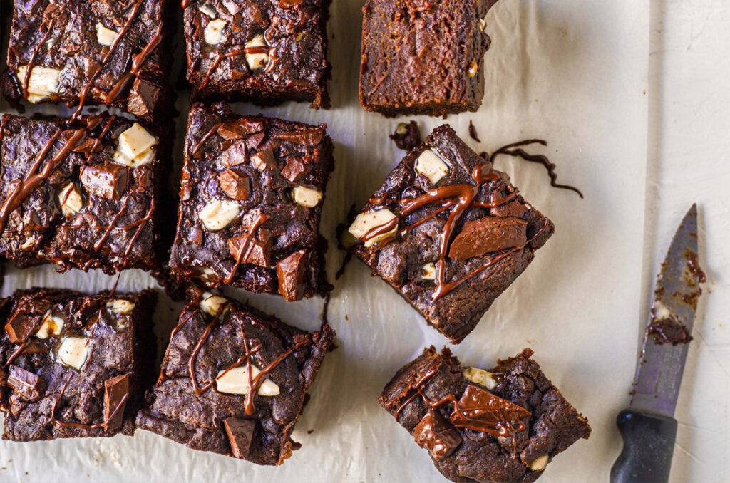 A close up image overhead of a slab of freshly cut brownies.