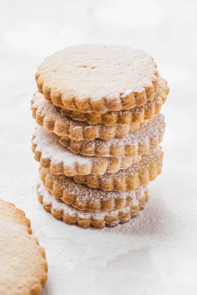 An image from above of a stack of dusted shortbread cookies.