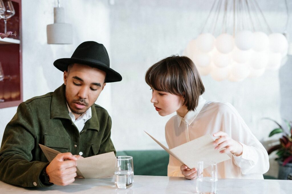 Couple in restaurant looking at menus.