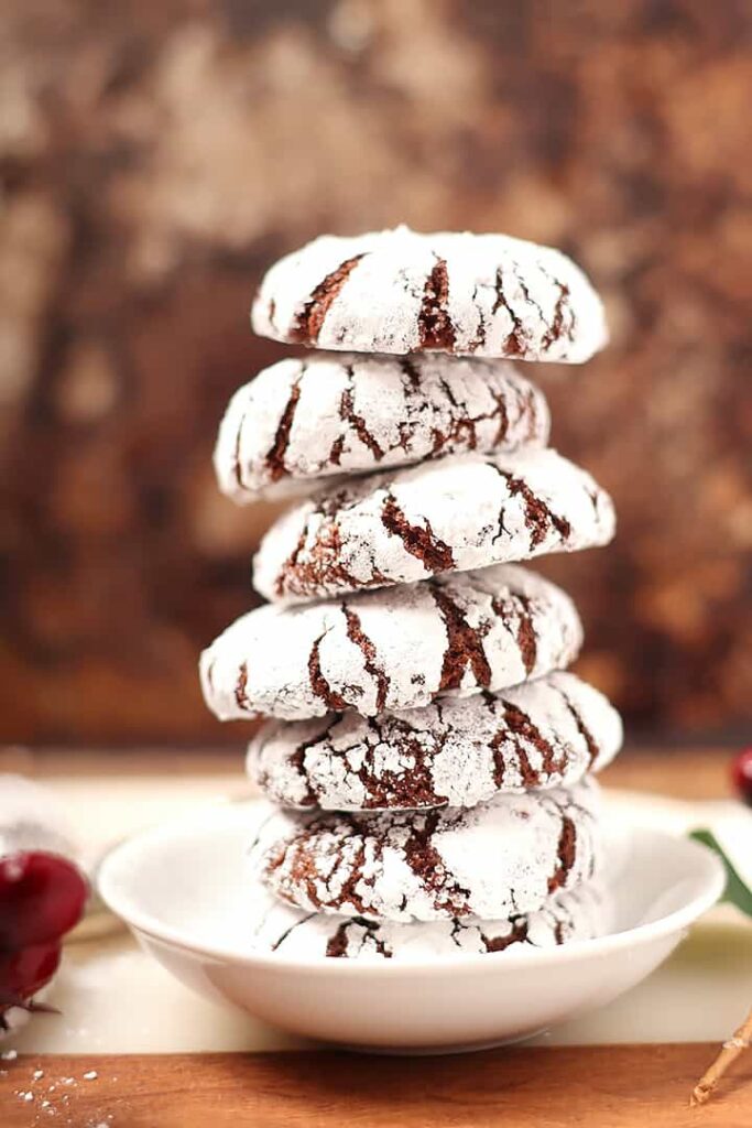 A close up image of dusted cookies piled up in a tower.