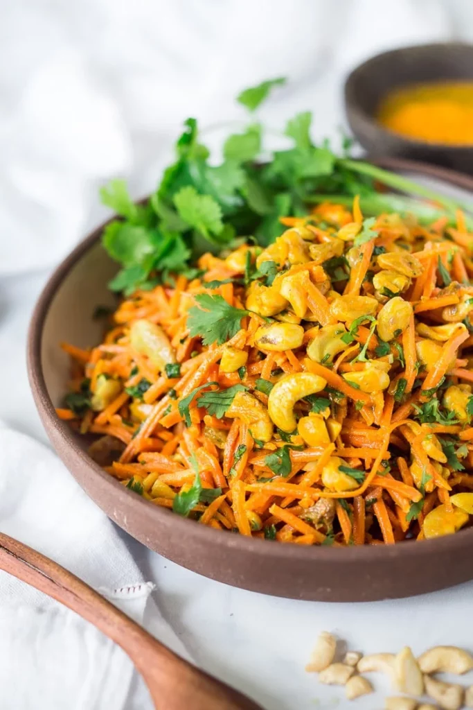 A brightly coloured salad of orange served in a bowl.