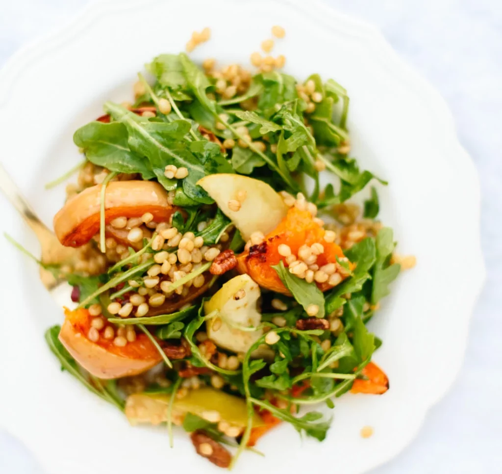 Overhead image of a Roasted Butternut Squash Salad on a white plate.