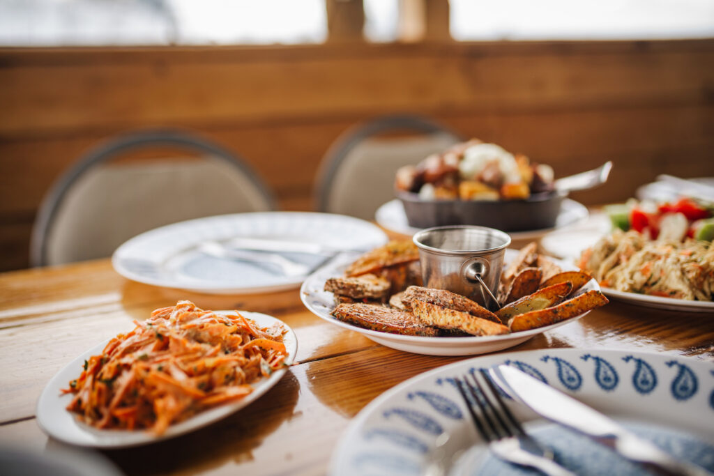 An assortment of four side dishes sit on a restaurant table.