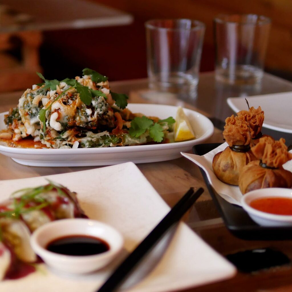 Three assorted Asian-style dishes sit on a table.