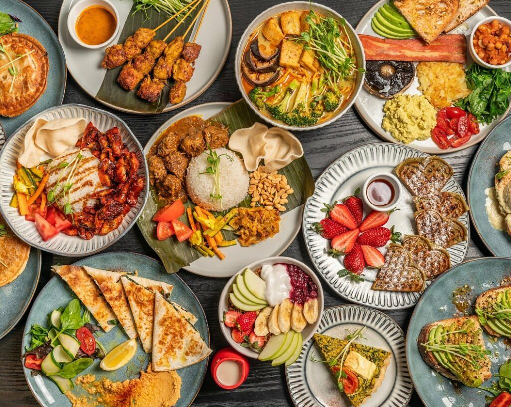 An overhead shot of a table full of various Asian-style dishes.