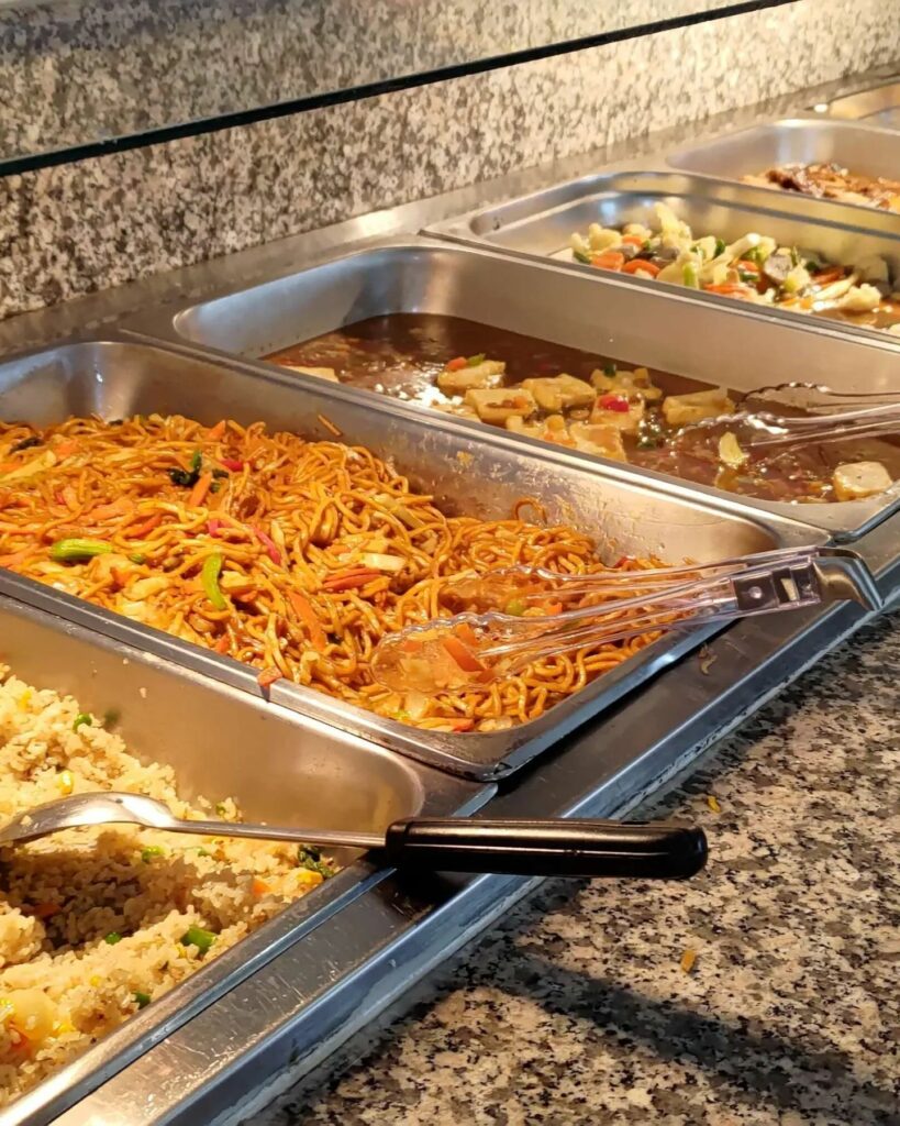 A range of different Asian-style dishes in a bain-marie.