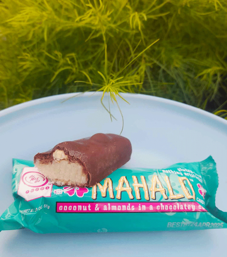 A Mahalo chocolate bar has been cut to reveal coconut nougat topped with roasted almonds.