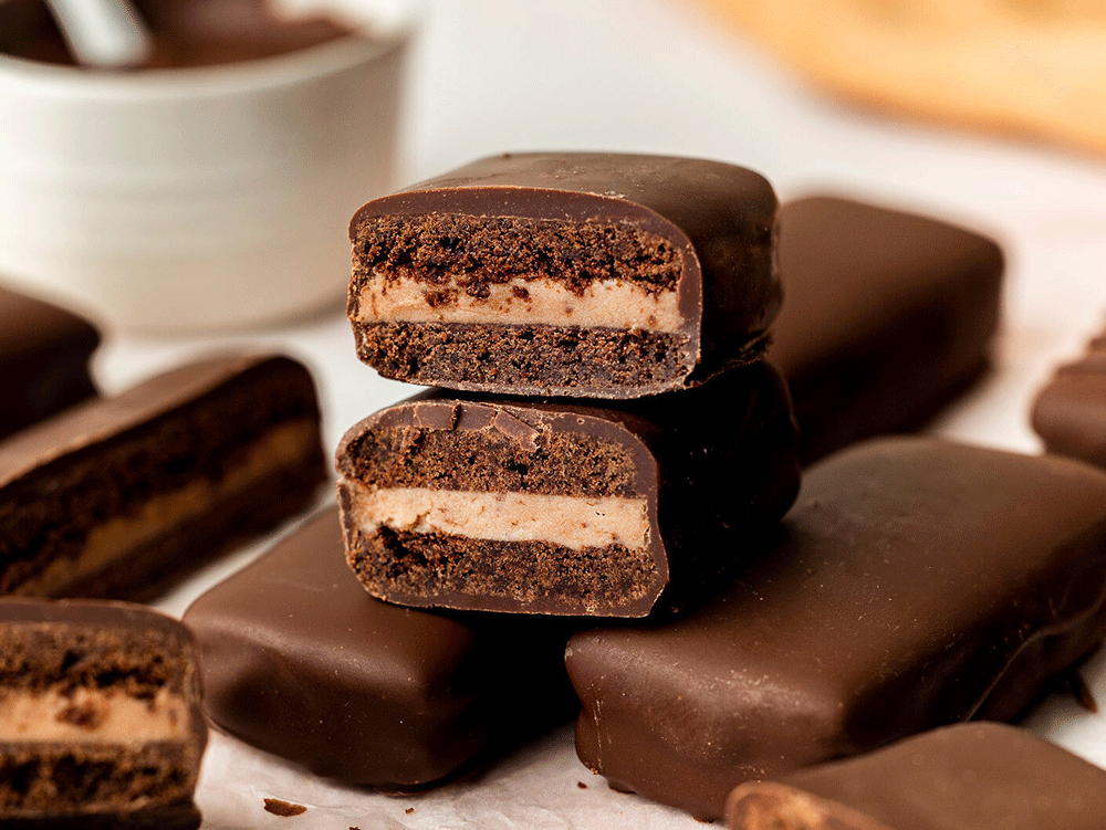 Home-made Tim Tam's on a bench, cut to show their cross section.