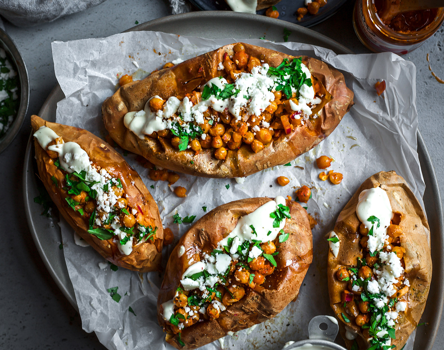 Delicious looking baked sweet potato with cheese and herbs on top