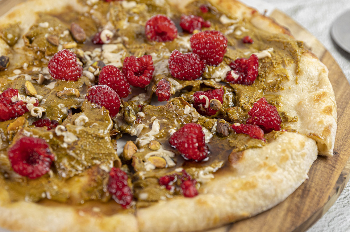 yummy looking vegan pizza with white chocolate and red berries