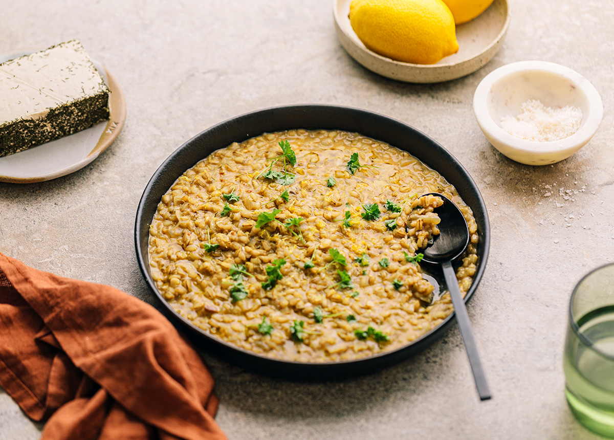 Creamy pearl barley risotto in a flat bowl