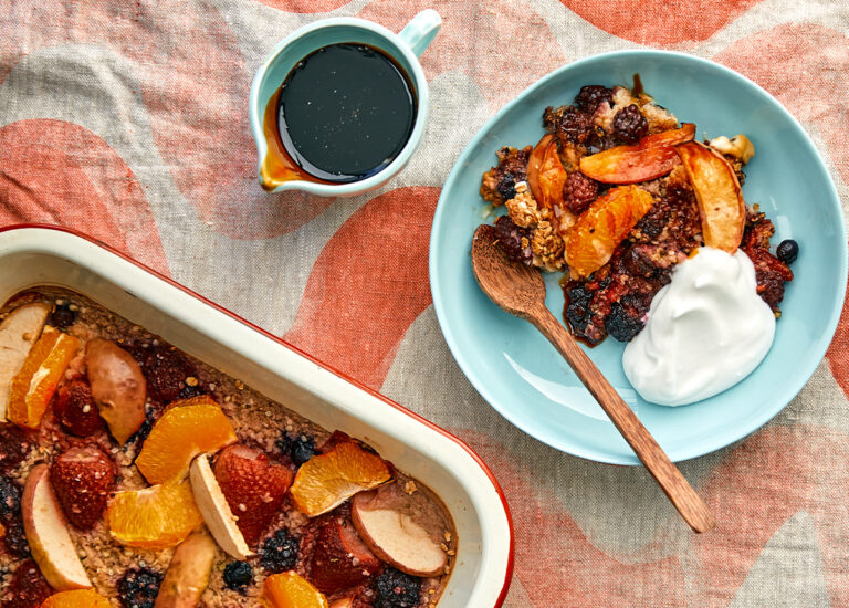 Fruity looking mixed berry baked oats in a bowl and in a baking dish.