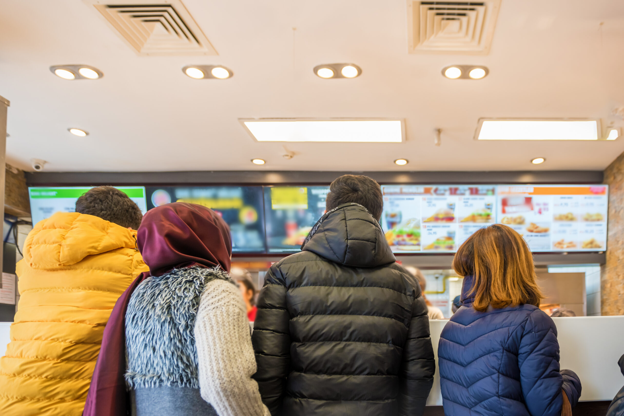 People waiting and queuing for order some food and make payment in fast food restaurant.